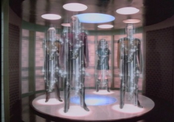 A Starfleet transporter in action; the glowing circles on the floor are the Phase Transition Coils; those above are the Primary Energizing coils