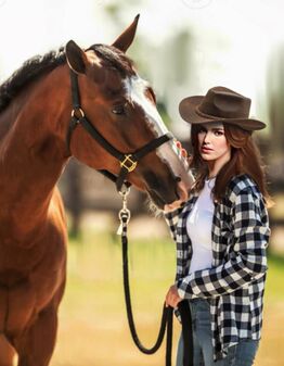 Alix at her chilhood home with her horse.